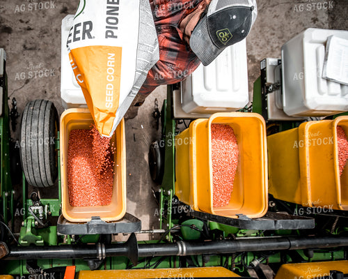 Farmer Filling Planter with Seed Bag 250161