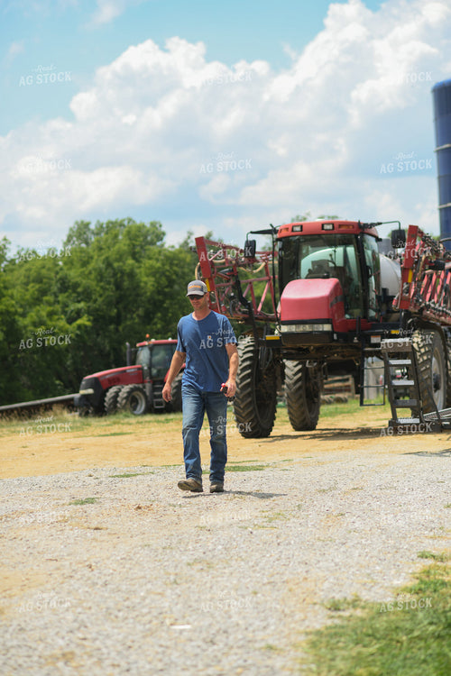 Farmer Walking by Sprayer 191230