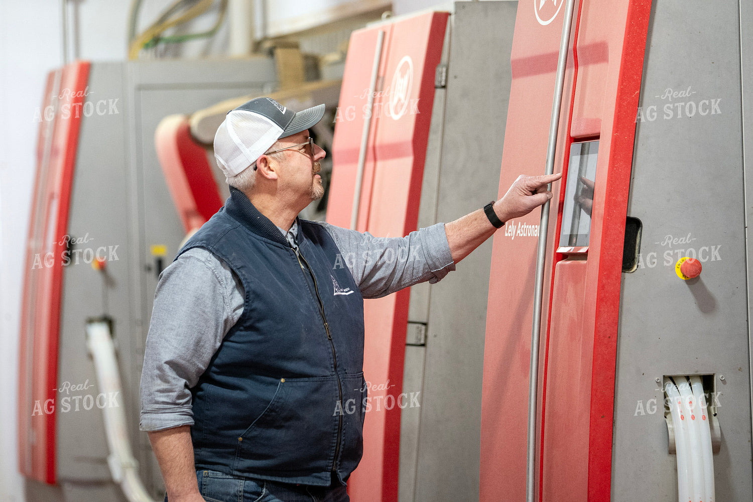 Farmer Adjusting Robotic Milking Unit 271038