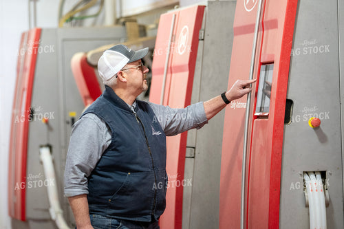 Farmer Adjusting Robotic Milking Unit 271038