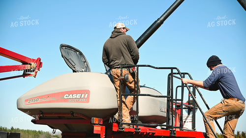 Farmer Loading the Planter with the Seed Tender 25096