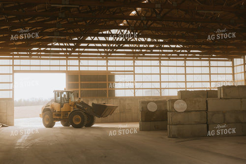 Tractor Loads Dry Feed in Storage Shed 7523