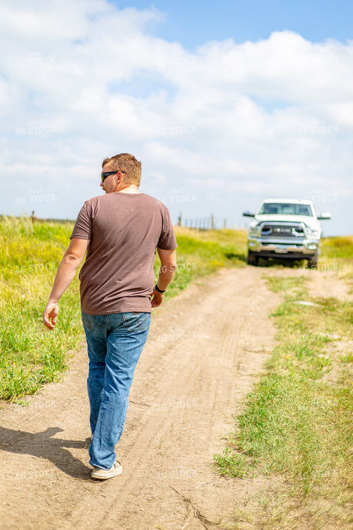 Farmer Waking on Dirt Road 155270