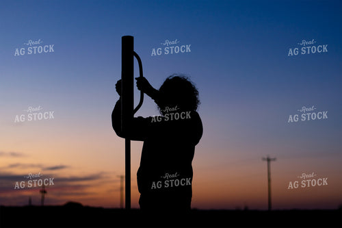 Farmer Pounding Fence Posts 50061