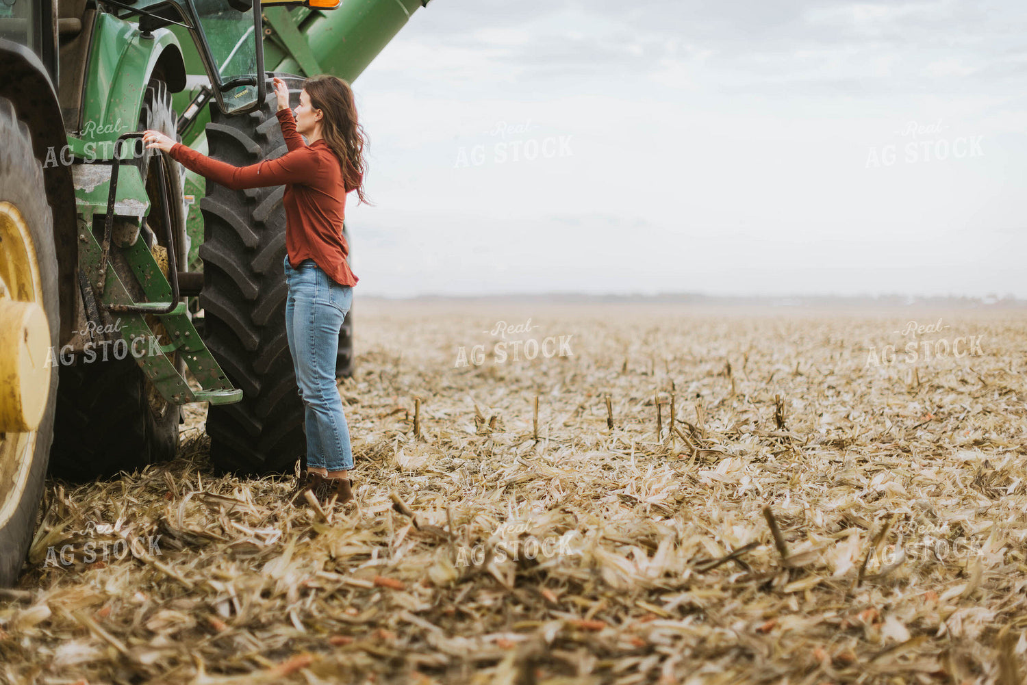 Female Farmer Cimbing into Tractor 8556