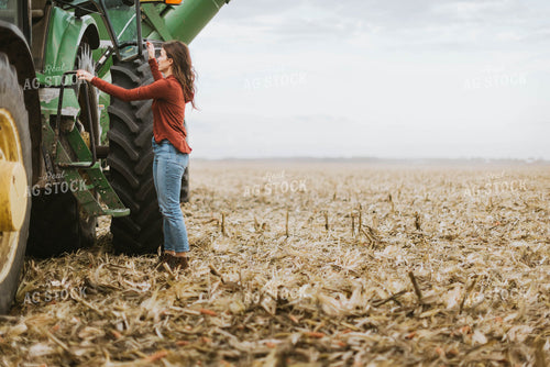 Female Farmer Cimbing into Tractor 8556