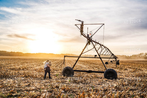 Female Farmer and Farm Kid Checking Pivot Irrigation 115384
