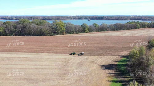 Aerial of Strip Tilling in Red Dirt with River in Background 79201