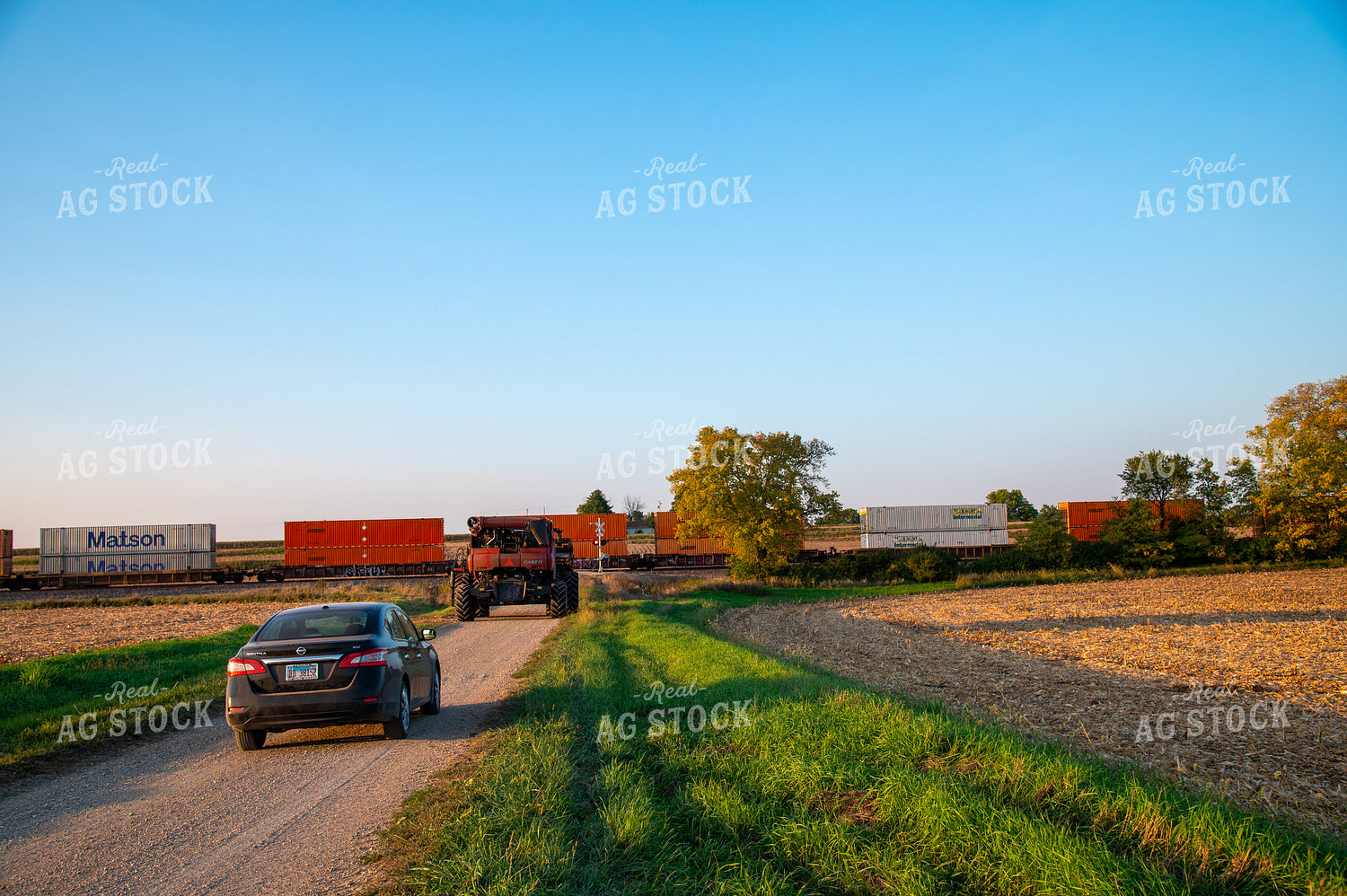 Combine Waiting for Train at Railroad Tracks 25451