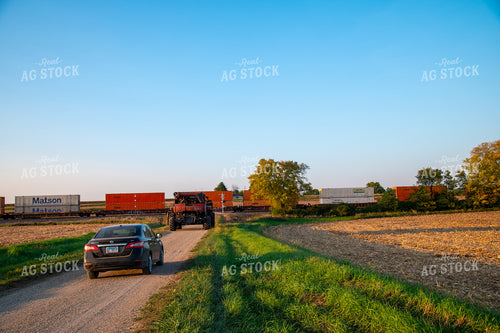 Combine Waiting for Train at Railroad Tracks 25451