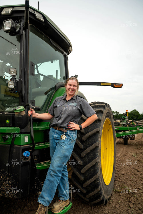 Female Farmer Climbing into Planter 115692
