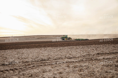 Large Tractor Plowing Field on a Dusty Spring Day 152475
