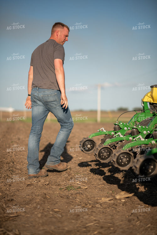 Farmer Walking Away from Planter 76378