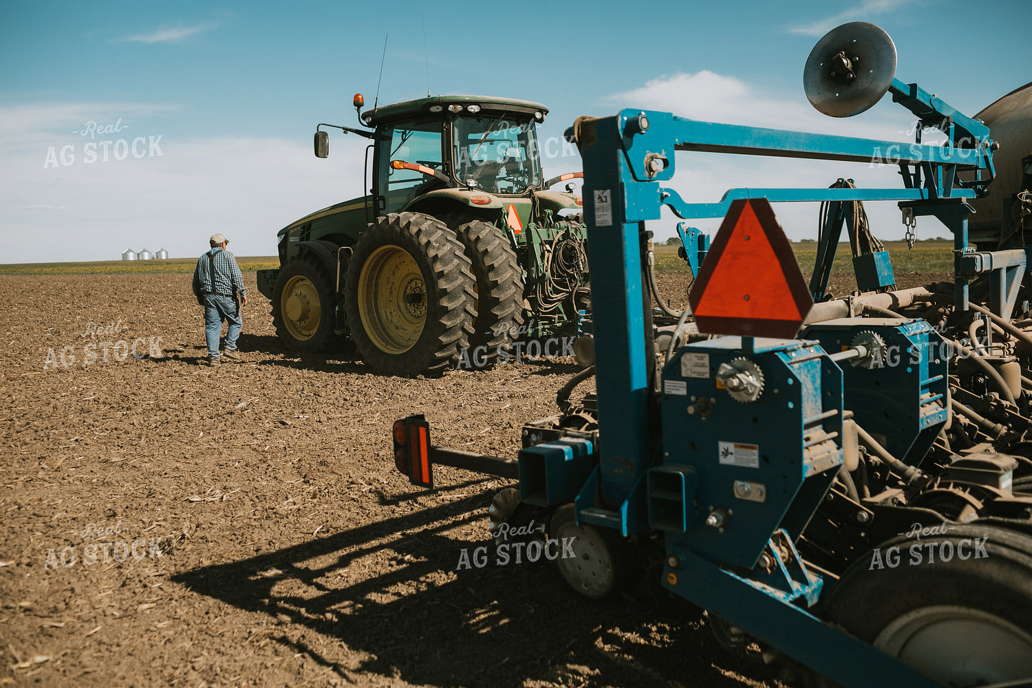Farmer Climbing into Tractor with Planter 4285