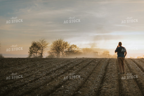 Farmer Talking on Phone in Field 7462