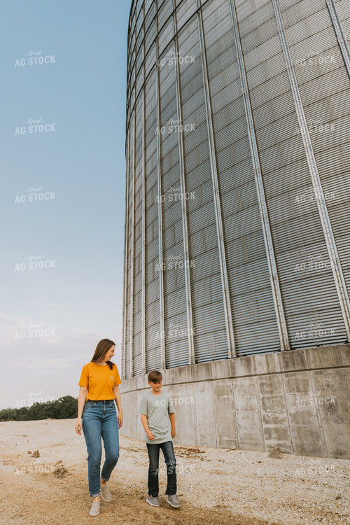 Farm Wife and Son Walk by Grain Bin 7802