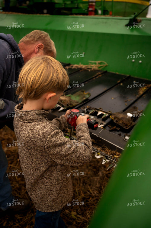 Farmer and Son Fixing Combine Head 115408