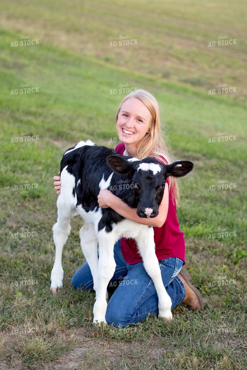 Female Farmer with Holstein Calf 55360