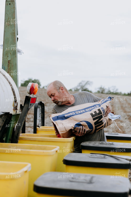 Farmer Filling Planter Boxes 77073