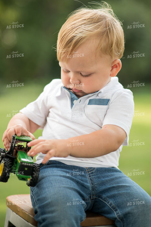 Farm Kid with Toy Tractor 76396