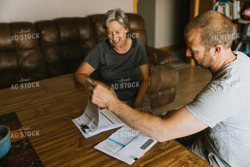 Farm Family Doing Bookwork 8115