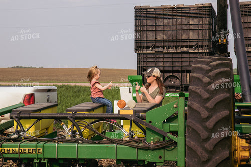 Female Farmer and Daughter Load Planter with Seed 67314