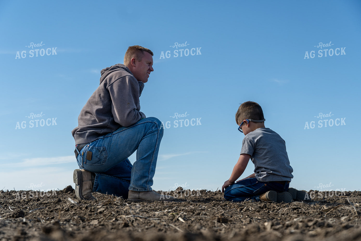 Farmer and Son Checking Seed Depth 65834