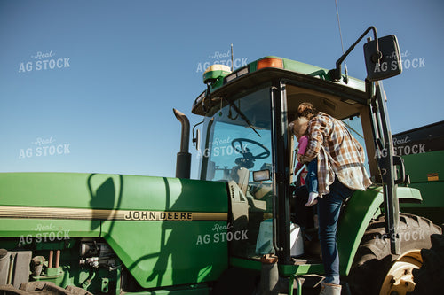 Female Farmer Loading Kids into Tractor 67541