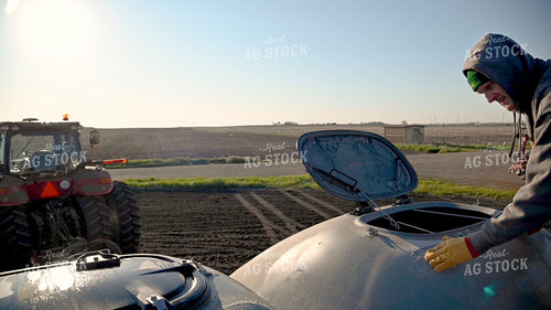 Farmer Loading the Planter with the Seed Tender 25203
