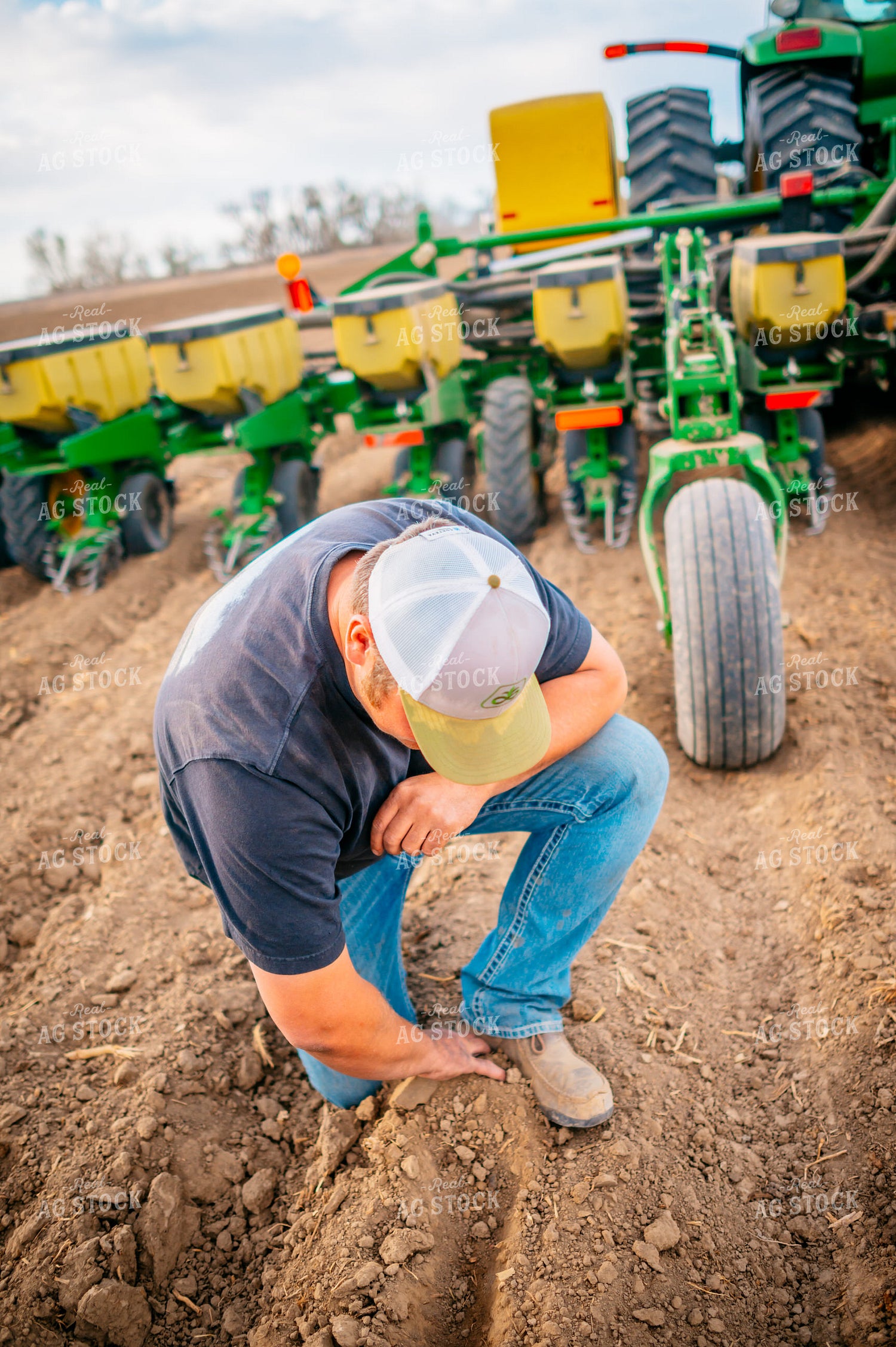 Farmer Checks Seed Depth Behind Planter 56652