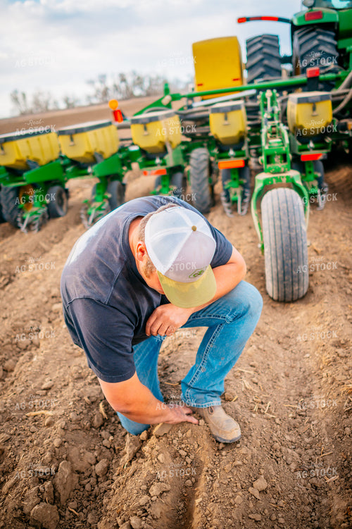 Farmer Checks Seed Depth Behind Planter 56652