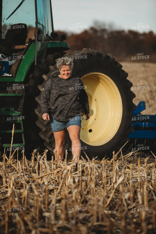 Female Farmer Getting out of Tractor with Disk 3624