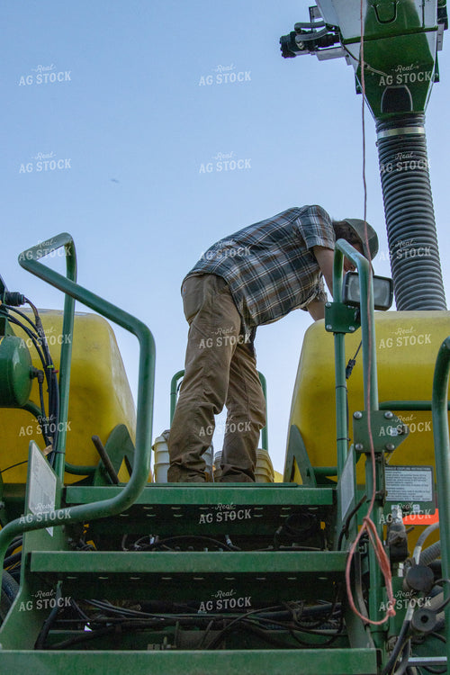 Farmer Loading Planter with Seed Tender 52110