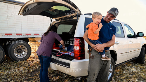 Father and Son Enjoying Harvest Meal in the Field 25773