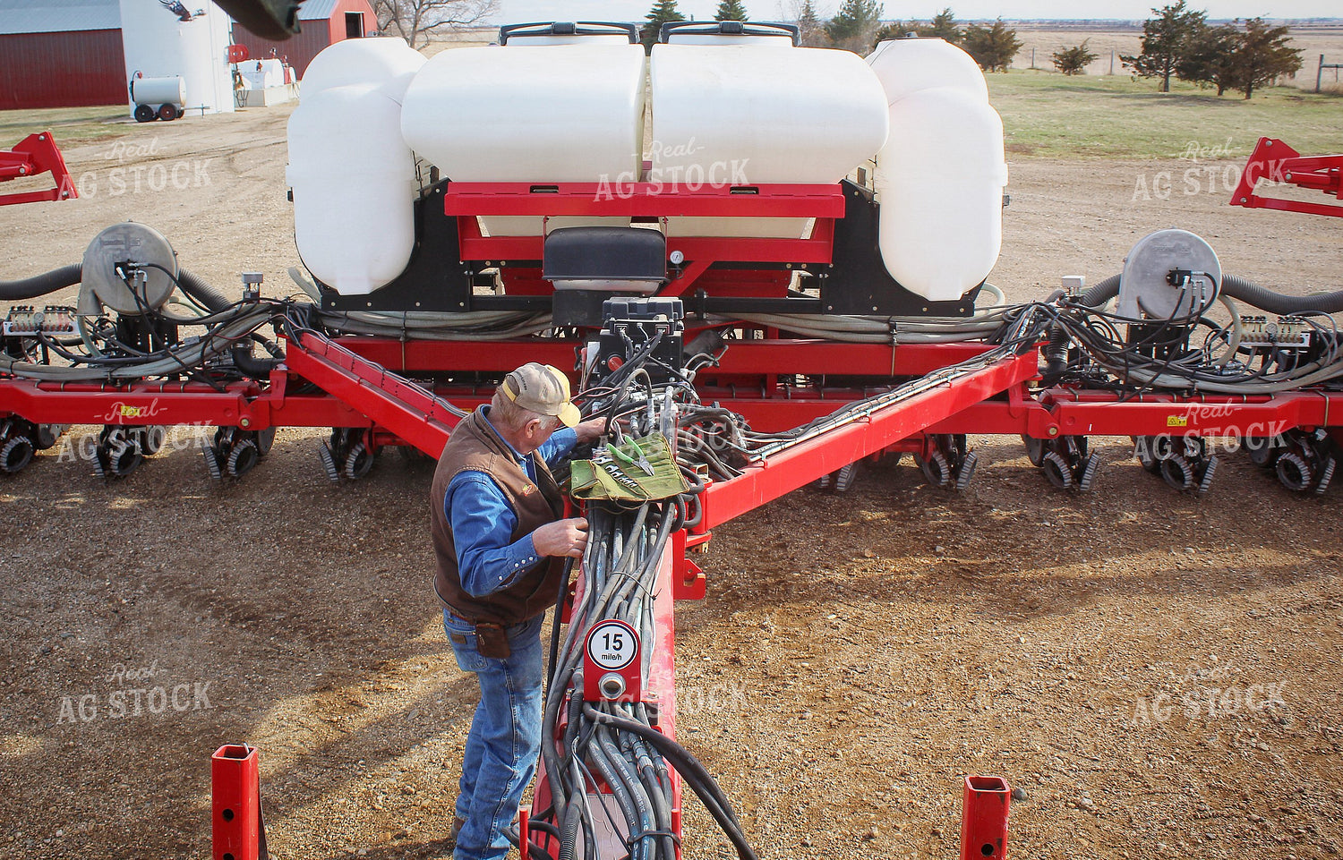 Farmer Fixing Planter 141206
