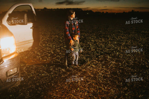 Farm Mom and Son Waiting for Tractor in Field at Night 5158