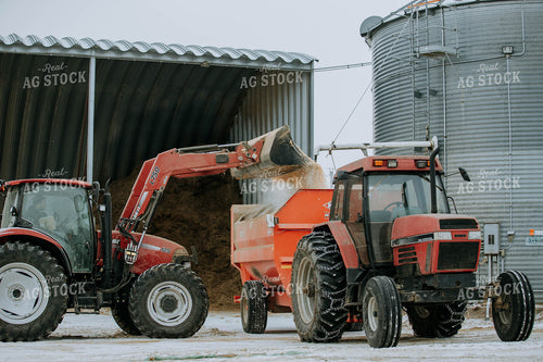 Tractor Emptying into feed mixer 77138