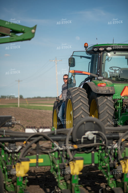Farmer Getting Out of Tractor 76366
