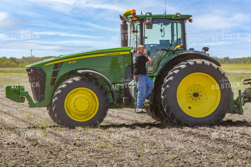 Farmer Climbs out of Tractor in Field 124024