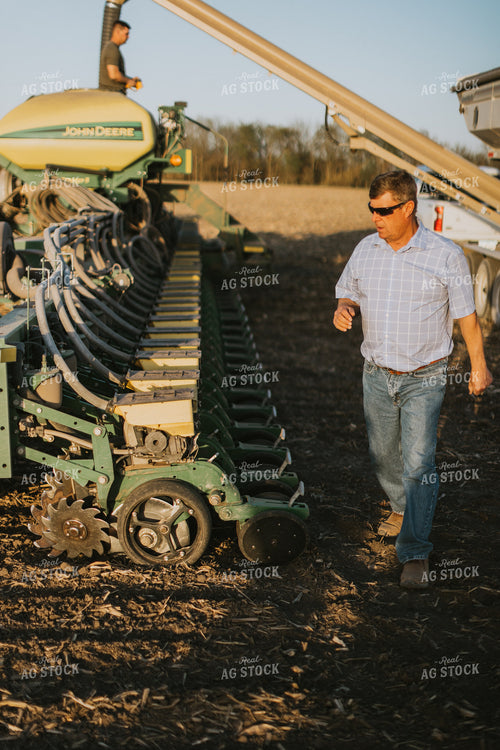 Farmer Walks Along Planter 7699