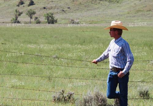Rancher Leaning on Fence 63078