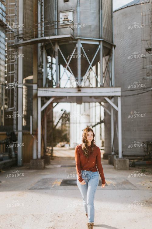 Female Farmer Walking by Grain Bins 8492