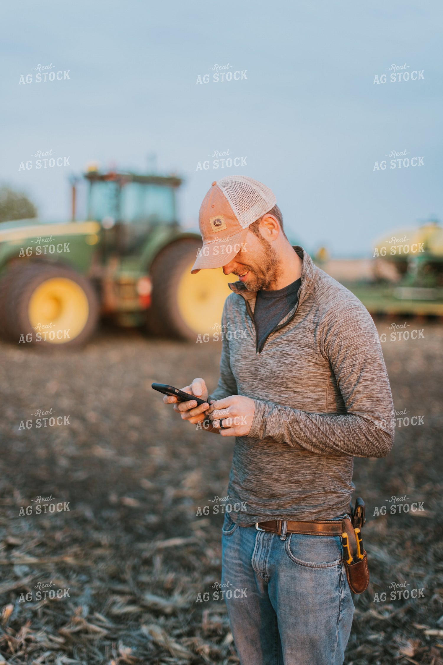 Farmer using Phone in Field by Planter 8247
