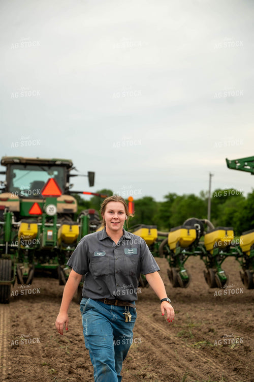 Female Farmer Checking Seed Depth Behind Planter 115700