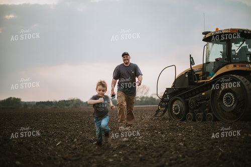 Farmer Walking Away From Planter Tractor with Farm Kid 5670