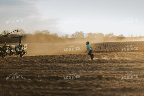 Farm Kid Running Towards Planter 7434