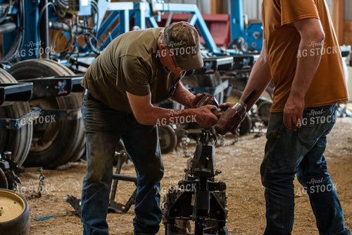 Farmers Working in Shed 50266