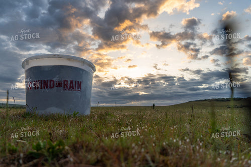 Outdoor Farmland Scene with a Mineral Feed Bucket Under a Dramatic Sky 65216