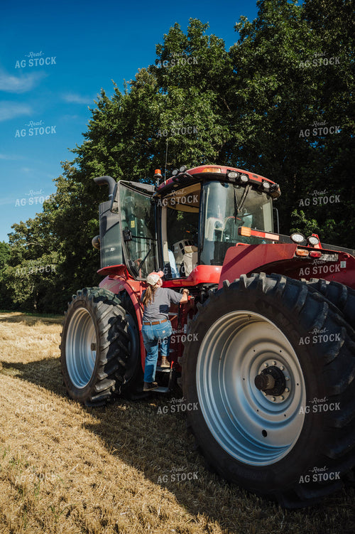 Female Farmer Climbing in Tractor 115216