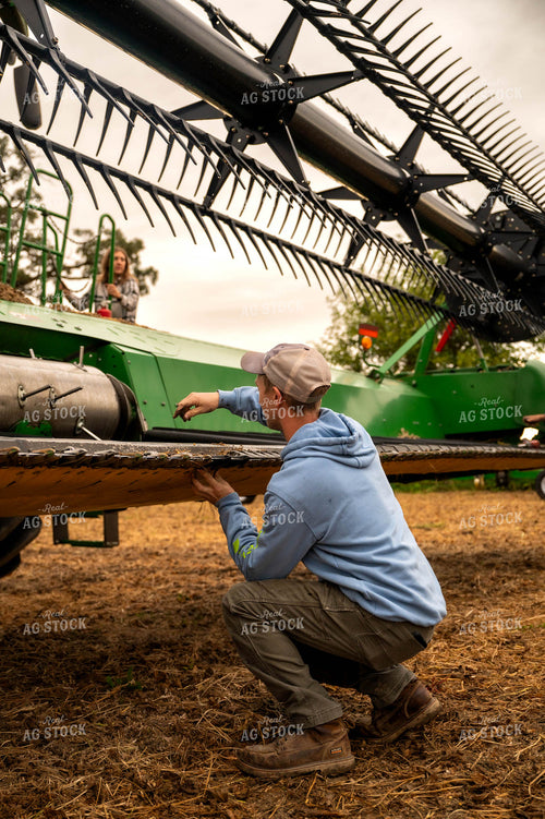 Farmer Fixing Combine Head 115413